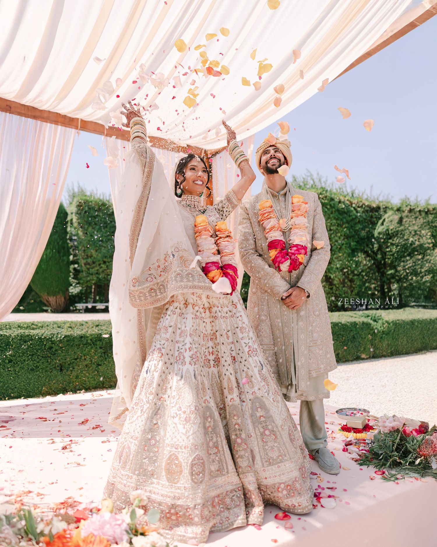 Traditional wedding ceremony setup with pink draping and floral decorations.