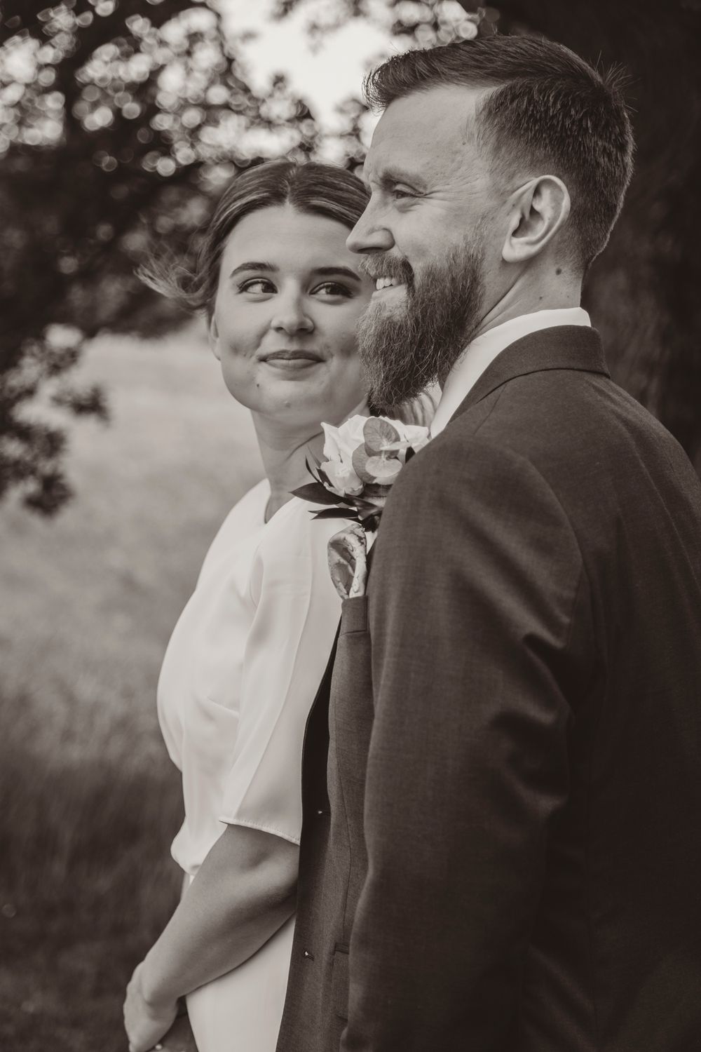 Black and white wedding photo sequence showing intimate moments between a couple in a romantic outdoor setting.