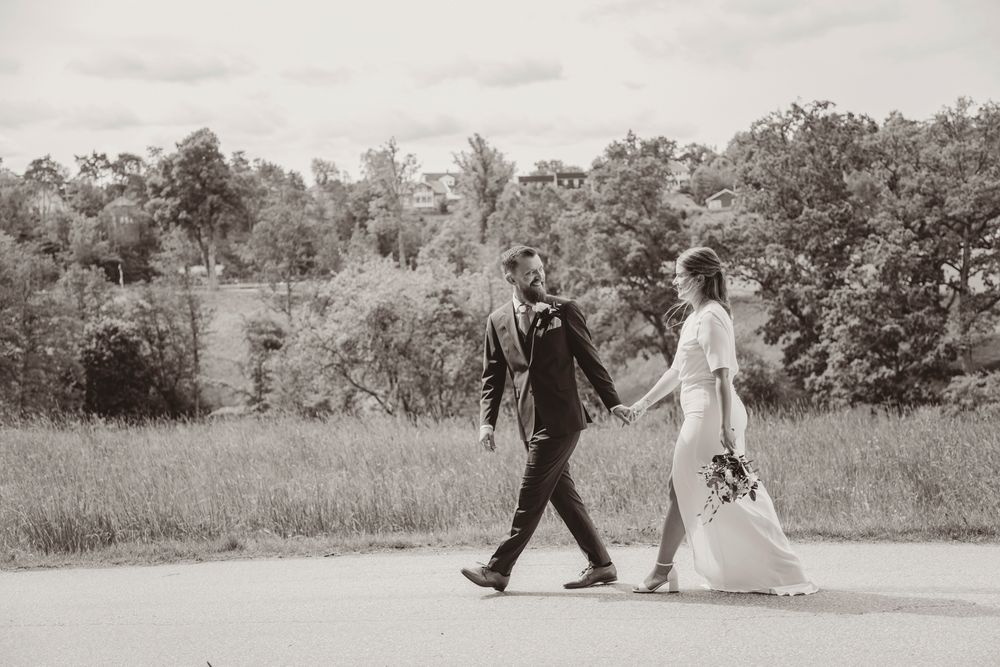 A series of black and white photographs showing people walking along a path through a scenic outdoor setting.