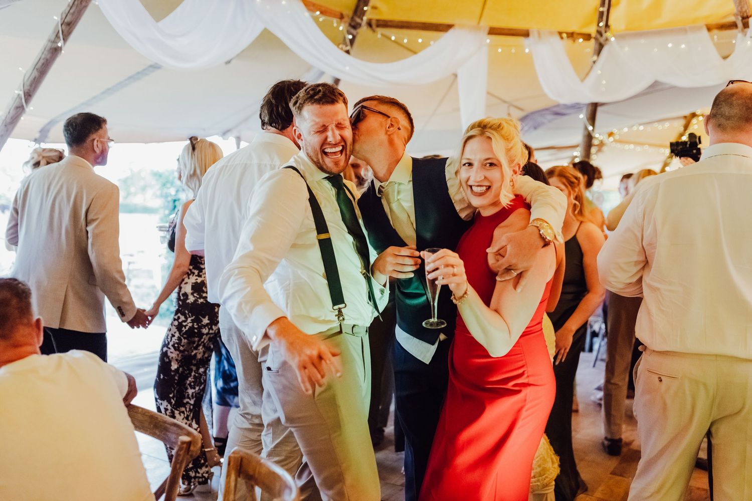 Wedding guests are dancing and celebrating joyfully during reception.