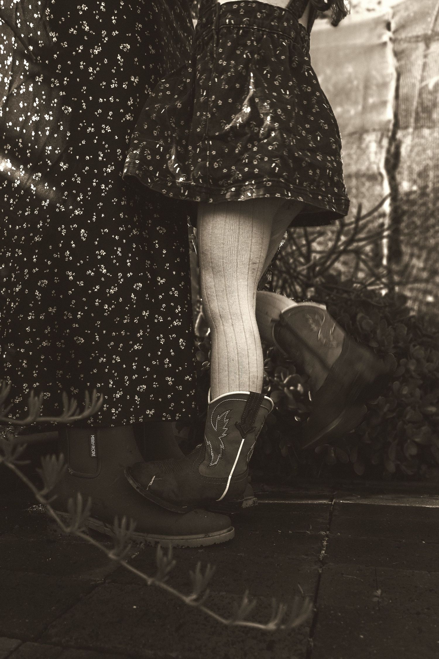 A sequence of photos showing a white sock and black shoe kicking off the ground in a jumping motion against a dark background.