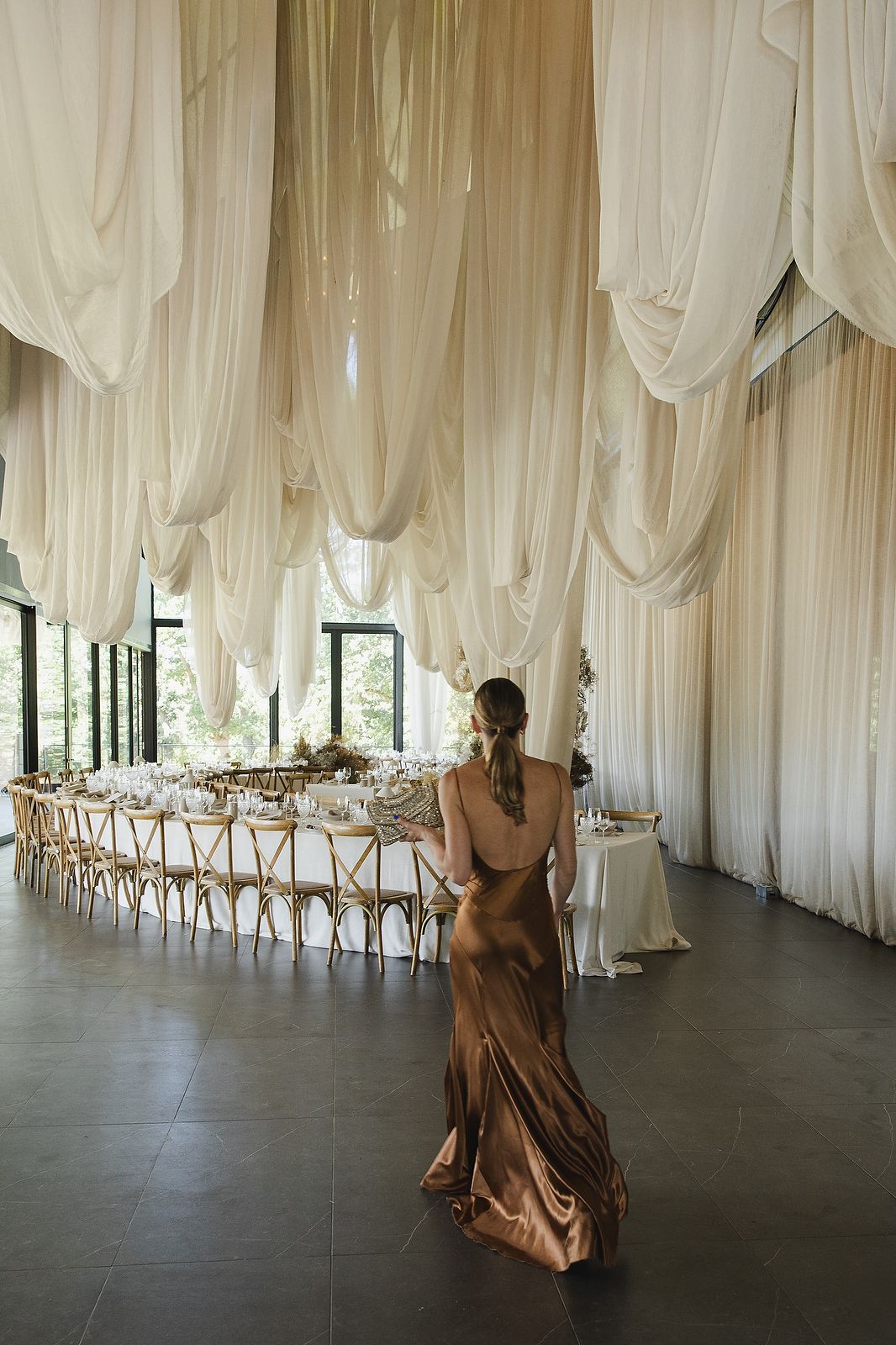 Sculptural draping paired with modern floral styling at the reception.