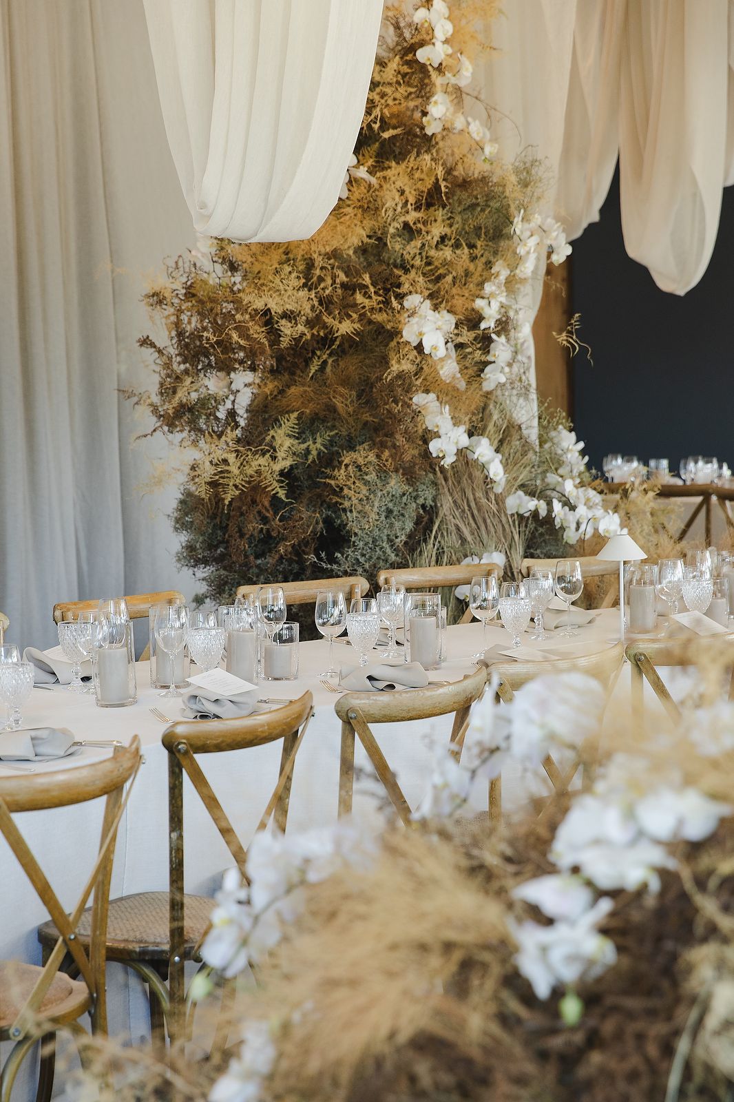 Reception space at Plaisir Wine Estate featuring textured florals and elegant décor.