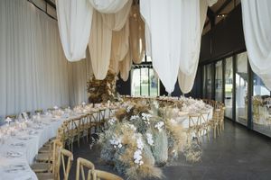 Refined wedding table décor with candles and organic floral accents.
