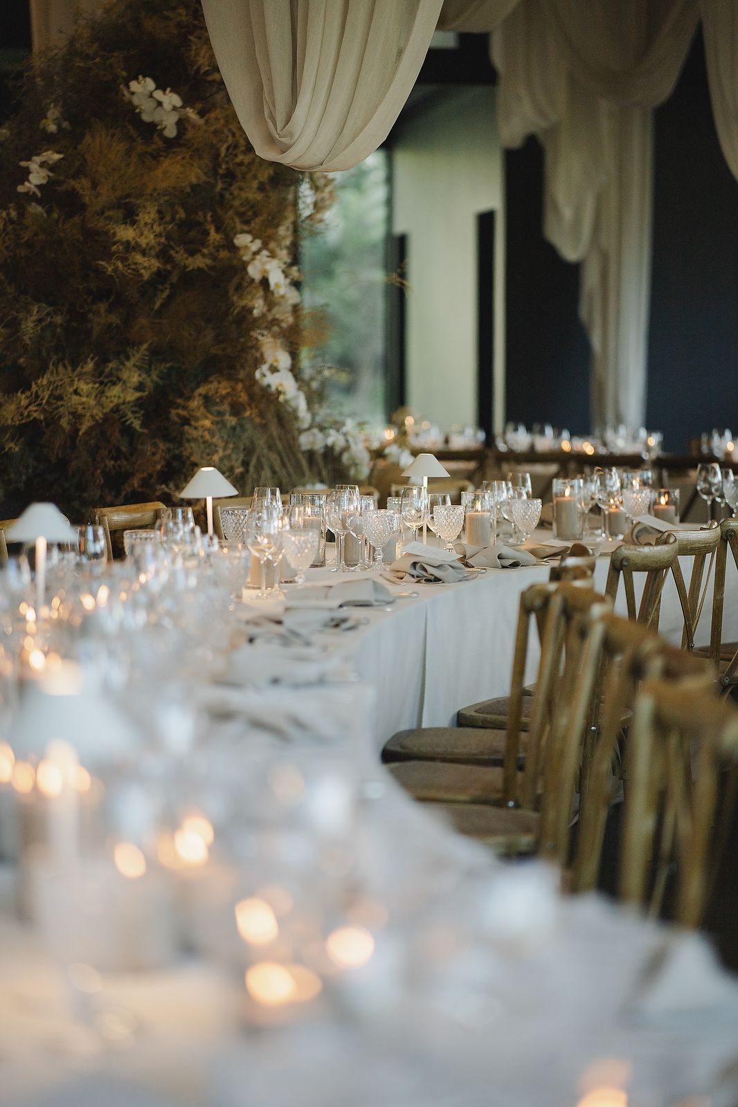 Understated luxury tablescape with elegant florals and candlelight.