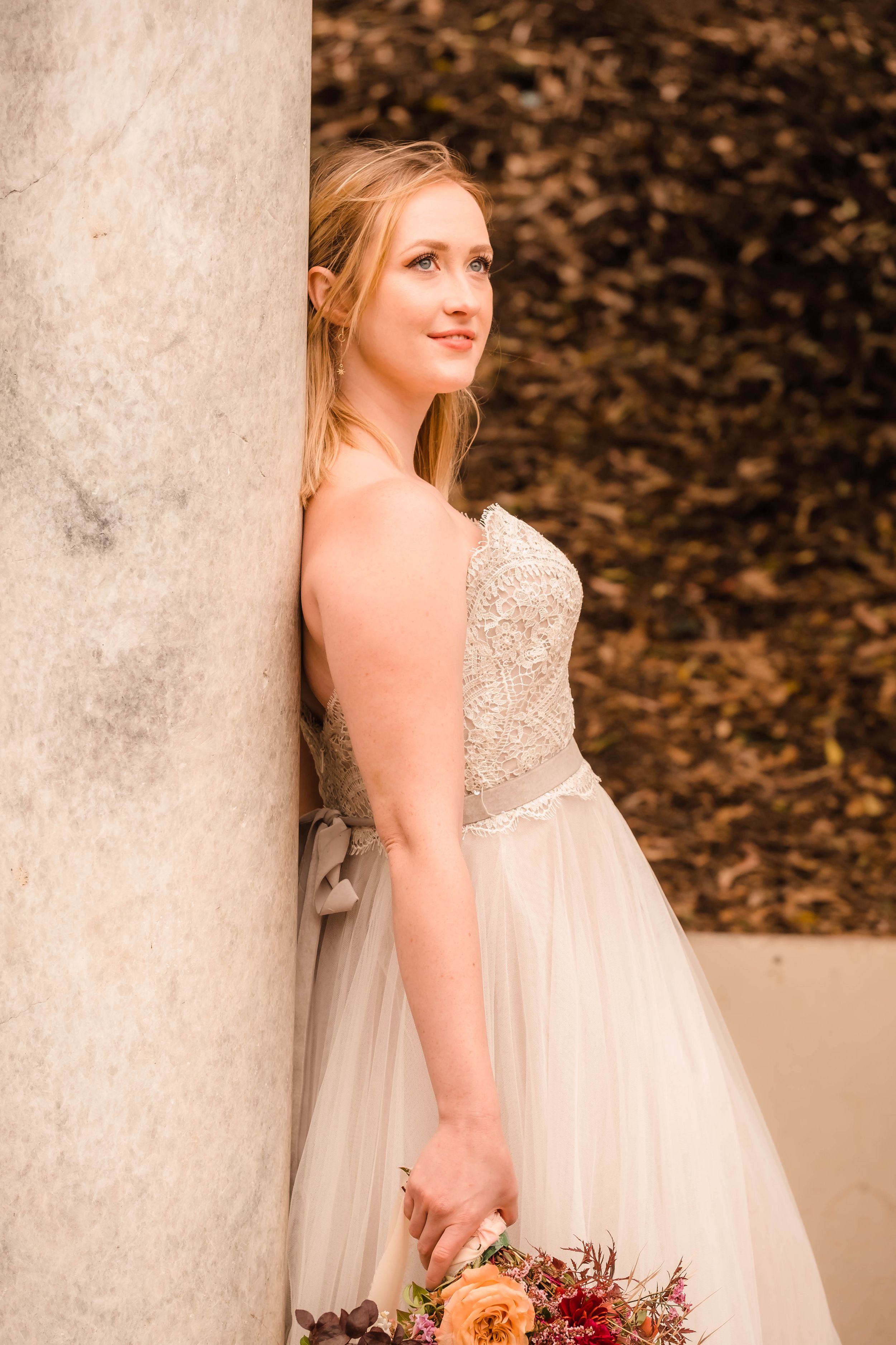 Sarah standing under the Portals of the Past arch in San Francisco during a cinematic elopement-style session.