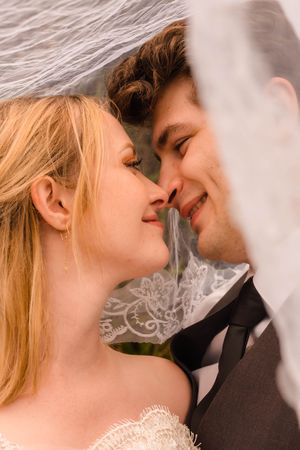 Emotional close-up of the couple embracing during their creative styled session. Dreamy under the veil shots.