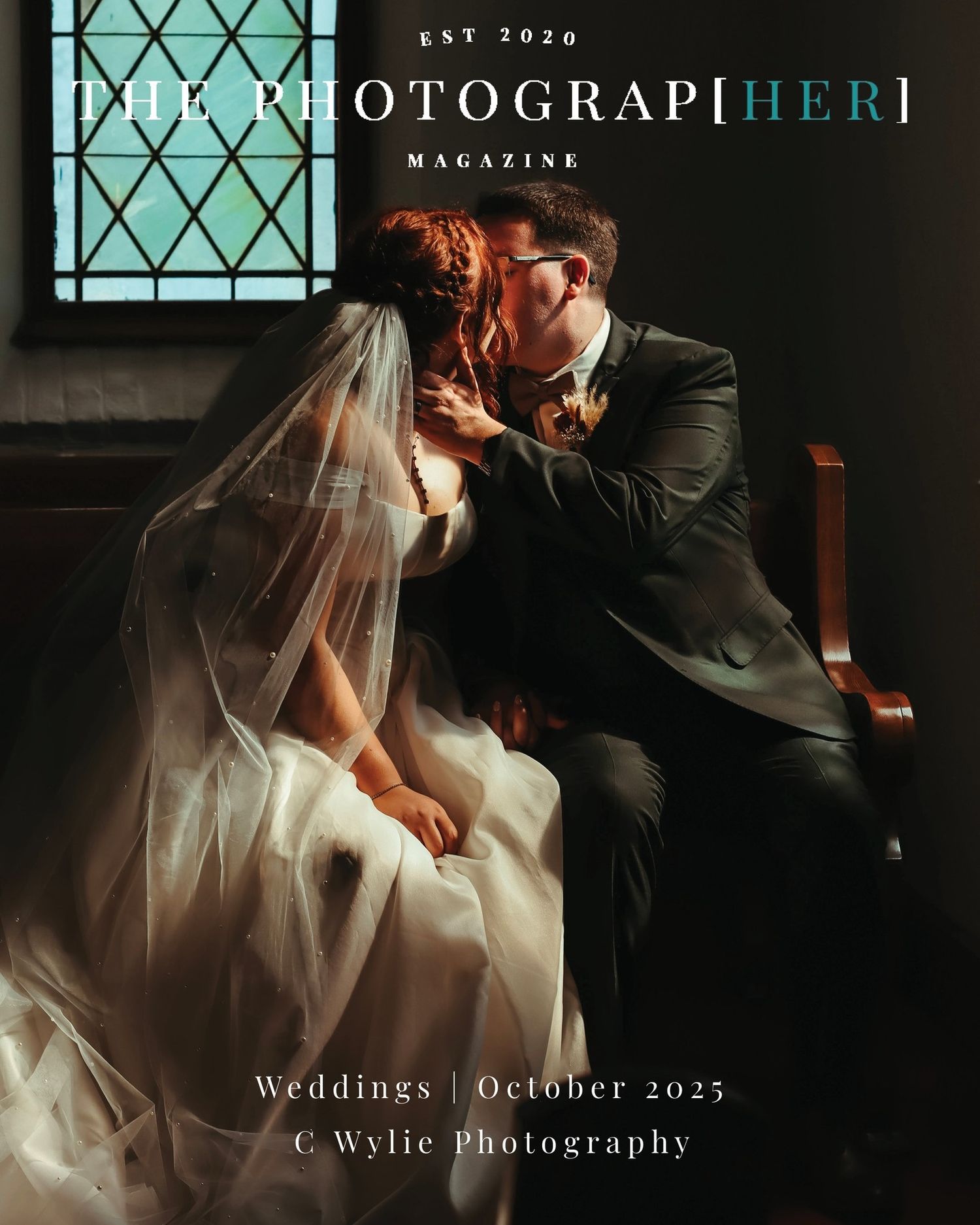 Romantic wedding couple shares an intimate moment in dramatic lighting with vintage windows in the background.