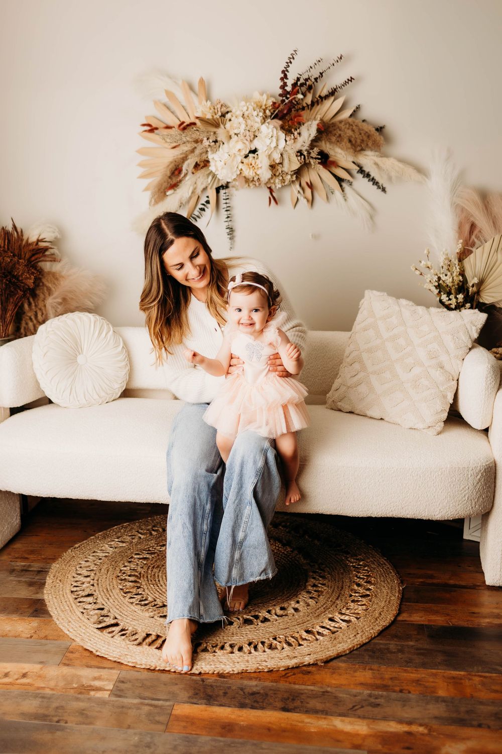 A sequence of candid lifestyle photos showing a white couch with decorative pillows and a round jute rug on wooden floors.