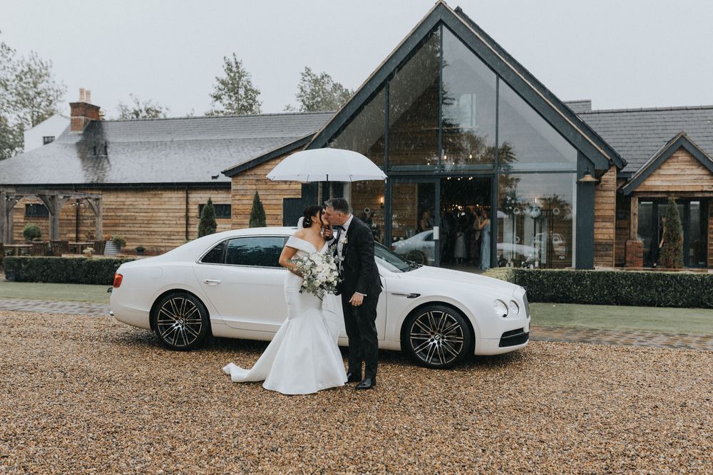 the river barn wedding photography bride groom rain