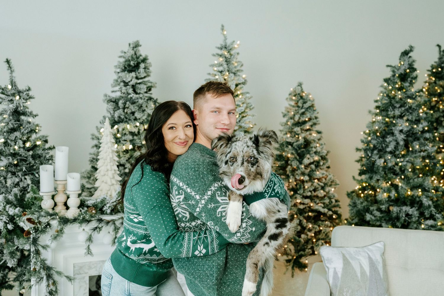 Christmas family photos in front of decorated evergreen trees and a winter backdrop.