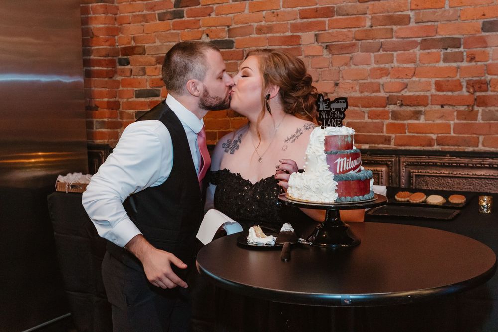A romantic moment shared between a couple at a rustic brick-walled restaurant.