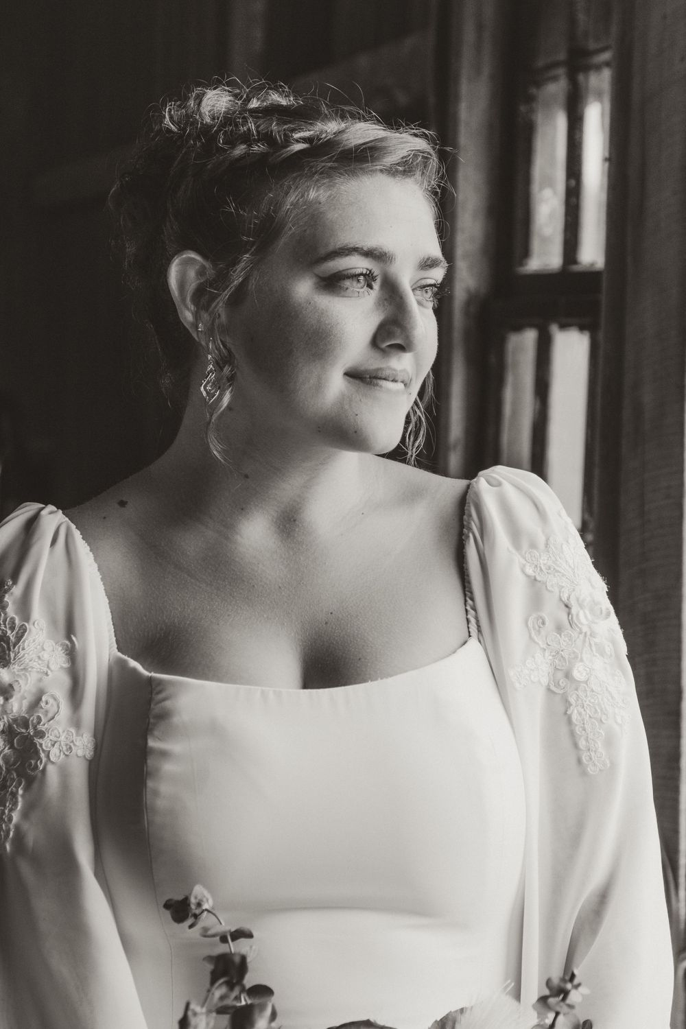 A series of black and white bridal portraits showing a wedding dress with delicate lace details and elegant neckline.
