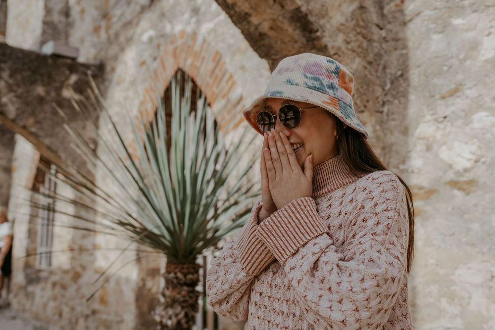 Candid engagement photos being captured at a rustic mission location.