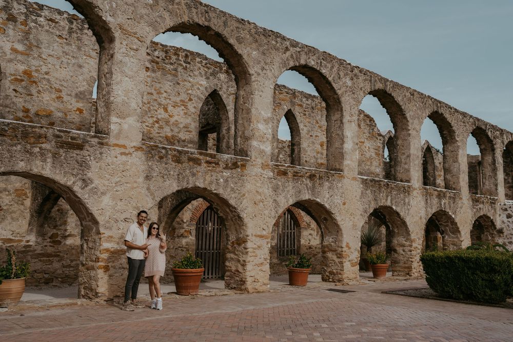 Stone archways and walkway of a historic mission or monastery.