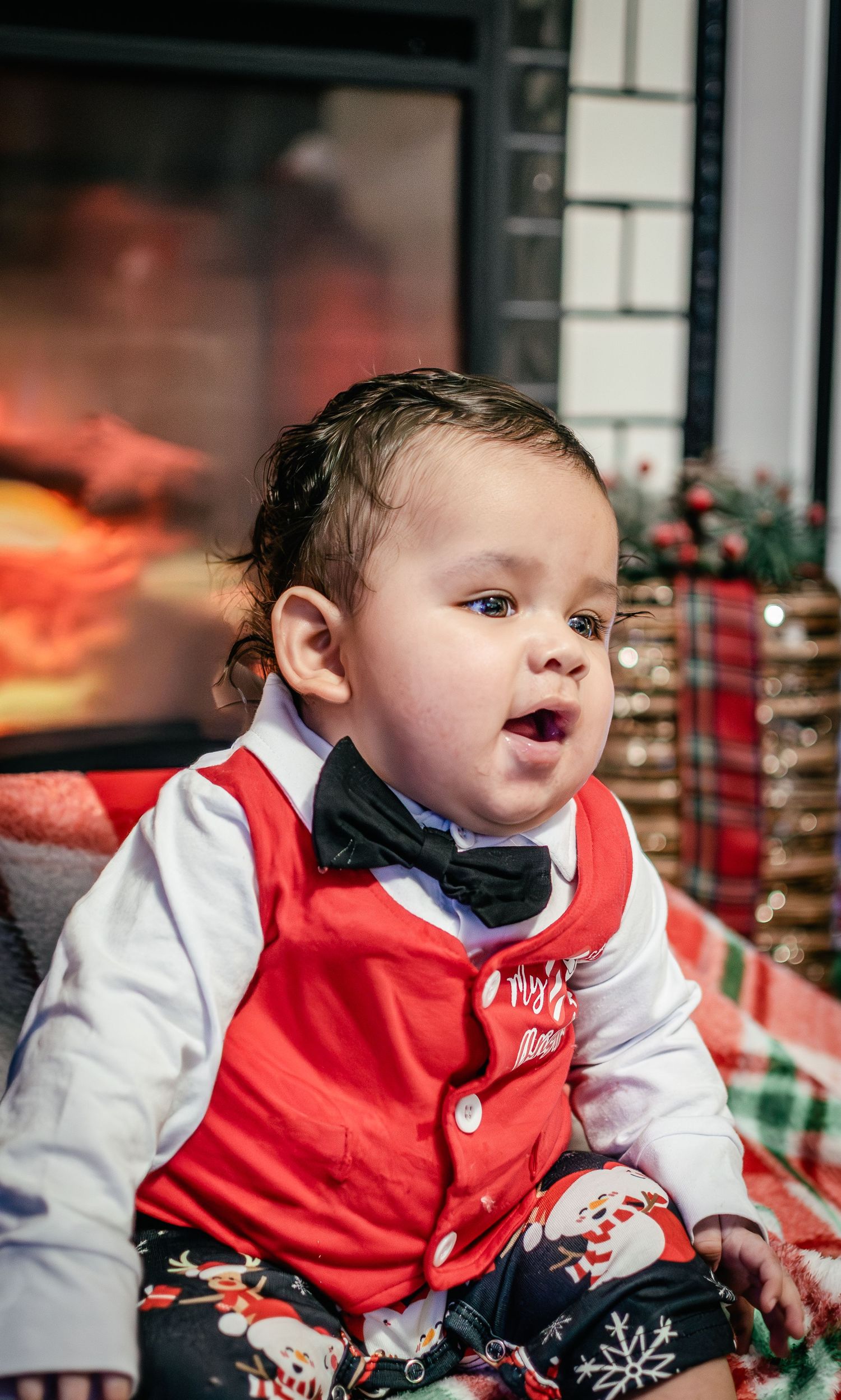 Four-month-old baby boy photographed during a cozy Christmas photo session in Puyallup Washington with fireplace.