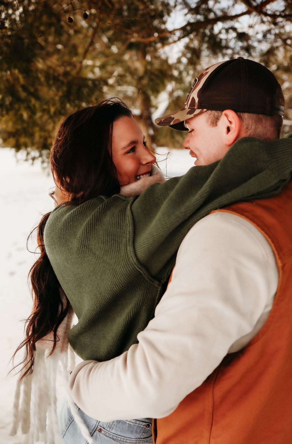 A couple embraces outdoors during a romantic autumn photoshoot with warm sunlight filtering through trees in Morris County, New Jersey park