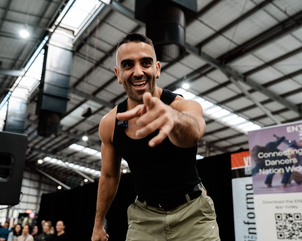 Person performs high-intensity workout exercises in a well-lit indoor gym facility.