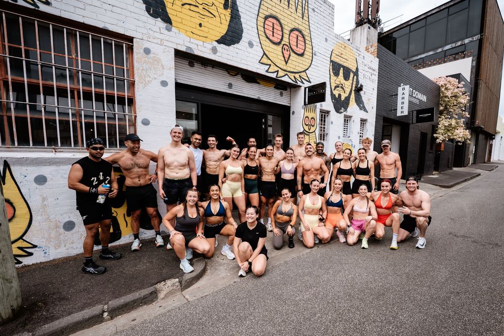 A group of people in underwear gather outside a building during a public event.