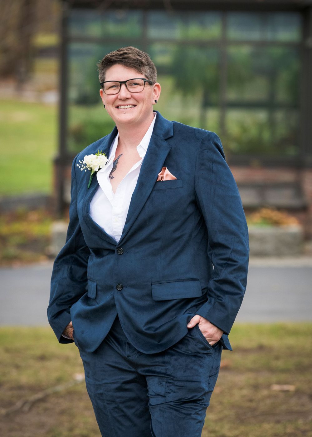Person in navy suit poses confidently outdoors in multiple casual stances.