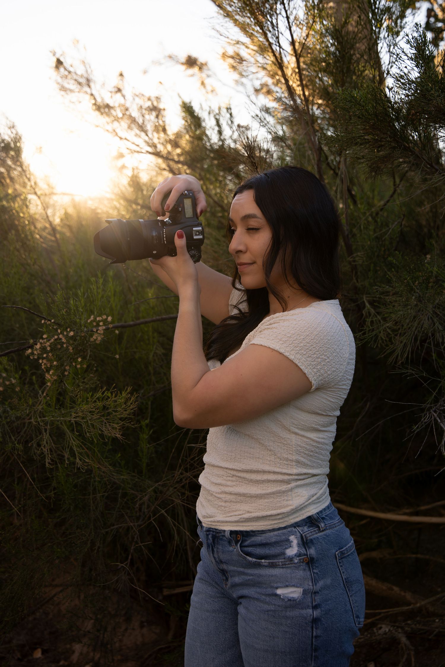 A photographer captures images in a desert setting during golden hour.