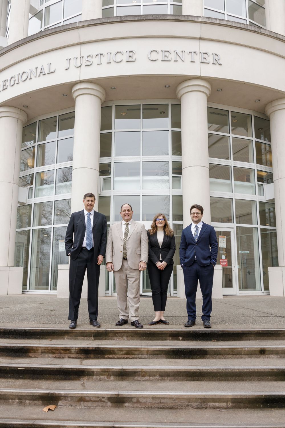 Smith McBroom law office attorney 3 men and 1 woman standing on steps of Kent Regal justice center for personal branding