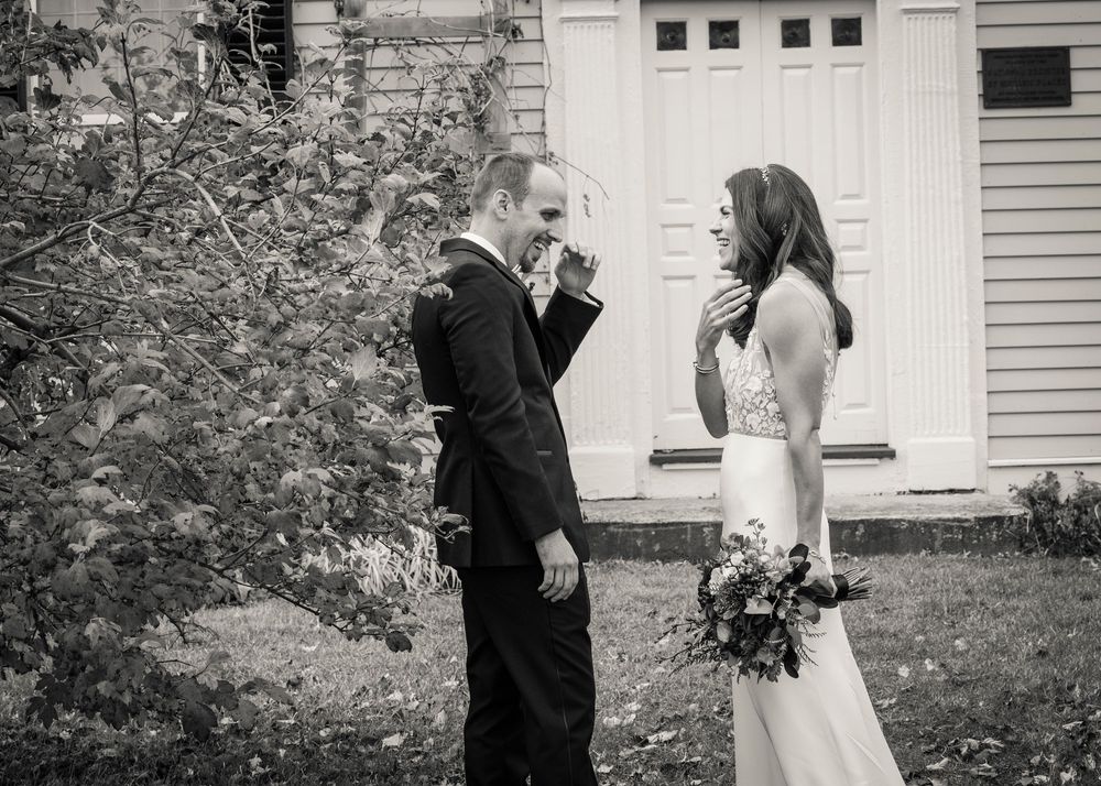 Black and white wedding photography sequence showing a couple posing in front of a white door.