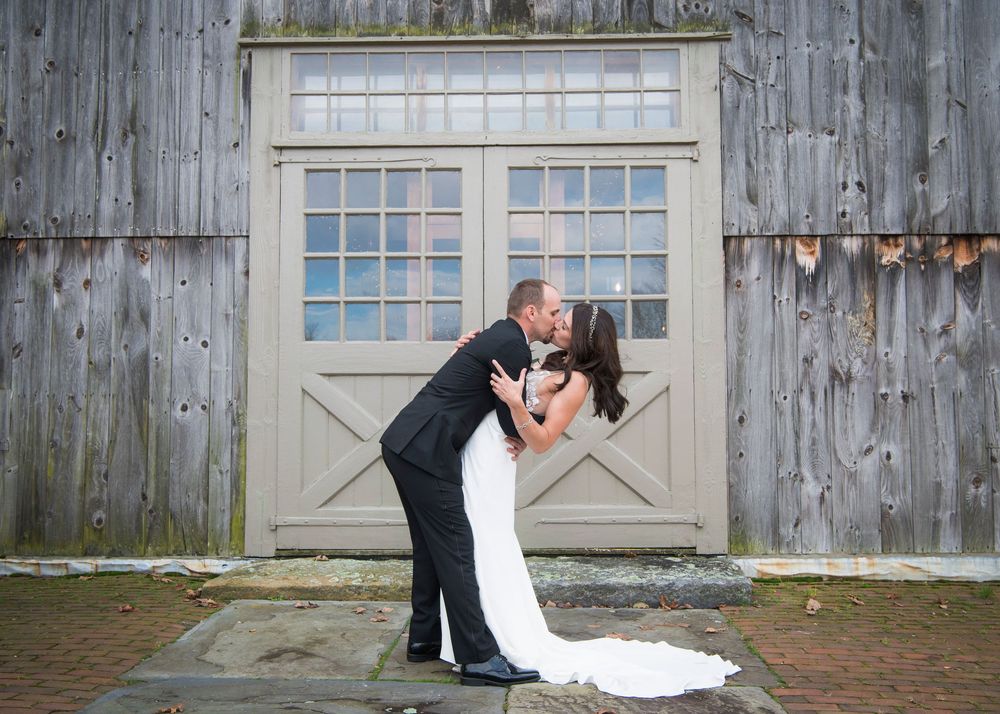 A series of romantic wedding photos showing a couple embracing against a rustic wooden barn backdrop.