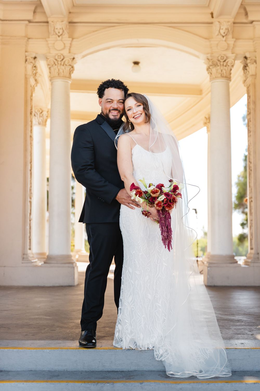 Bride and groom take wedding portraits at Spreckels Organ Pavilion in Balboa Park