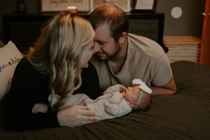 Intimate lifestyle photos capturing tender moments between parents and baby.