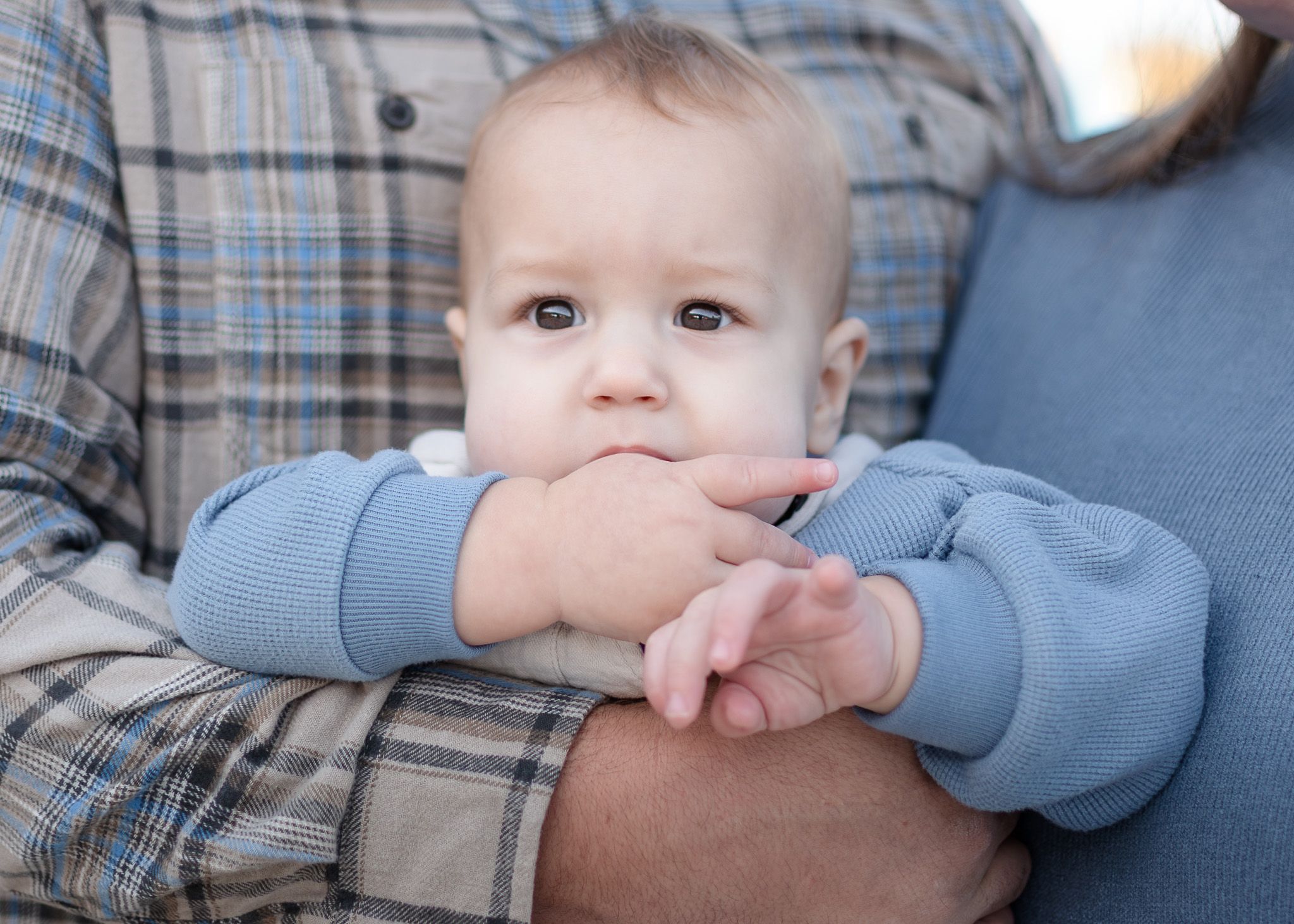 Baby resting in parent’s arms during family session with a Belton Texas family photographer