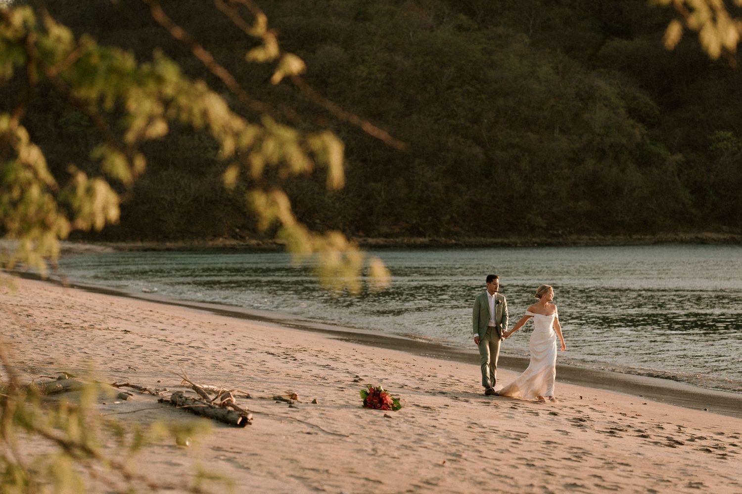 couple walking at the beach at sunset
