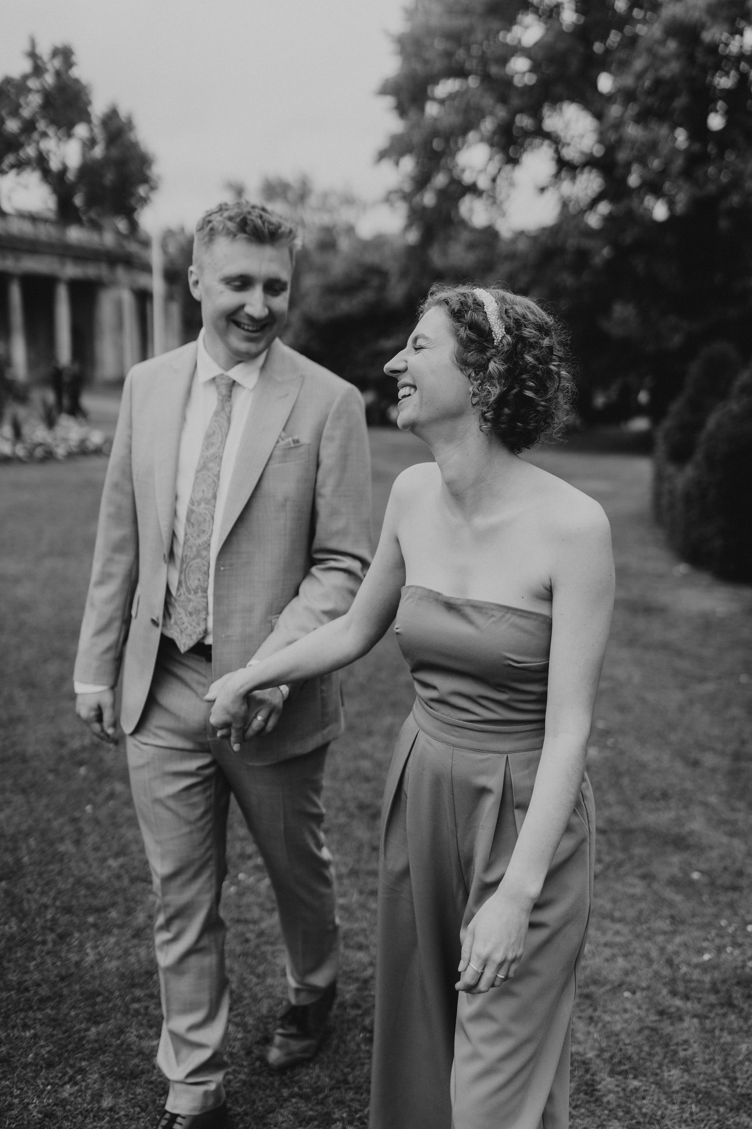 Bride and groom walking through Parade Garden  near Bath Guildhall. Wedding Couple portraits in Bath