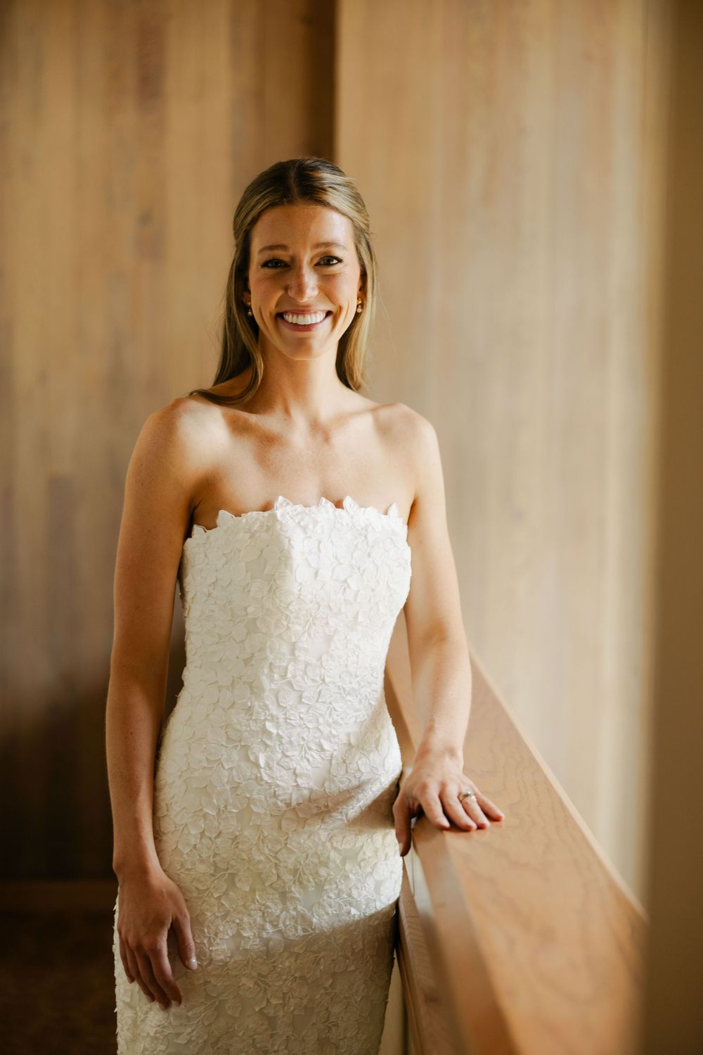 A series of five photos showing a white lace wedding dress against a soft beige background.