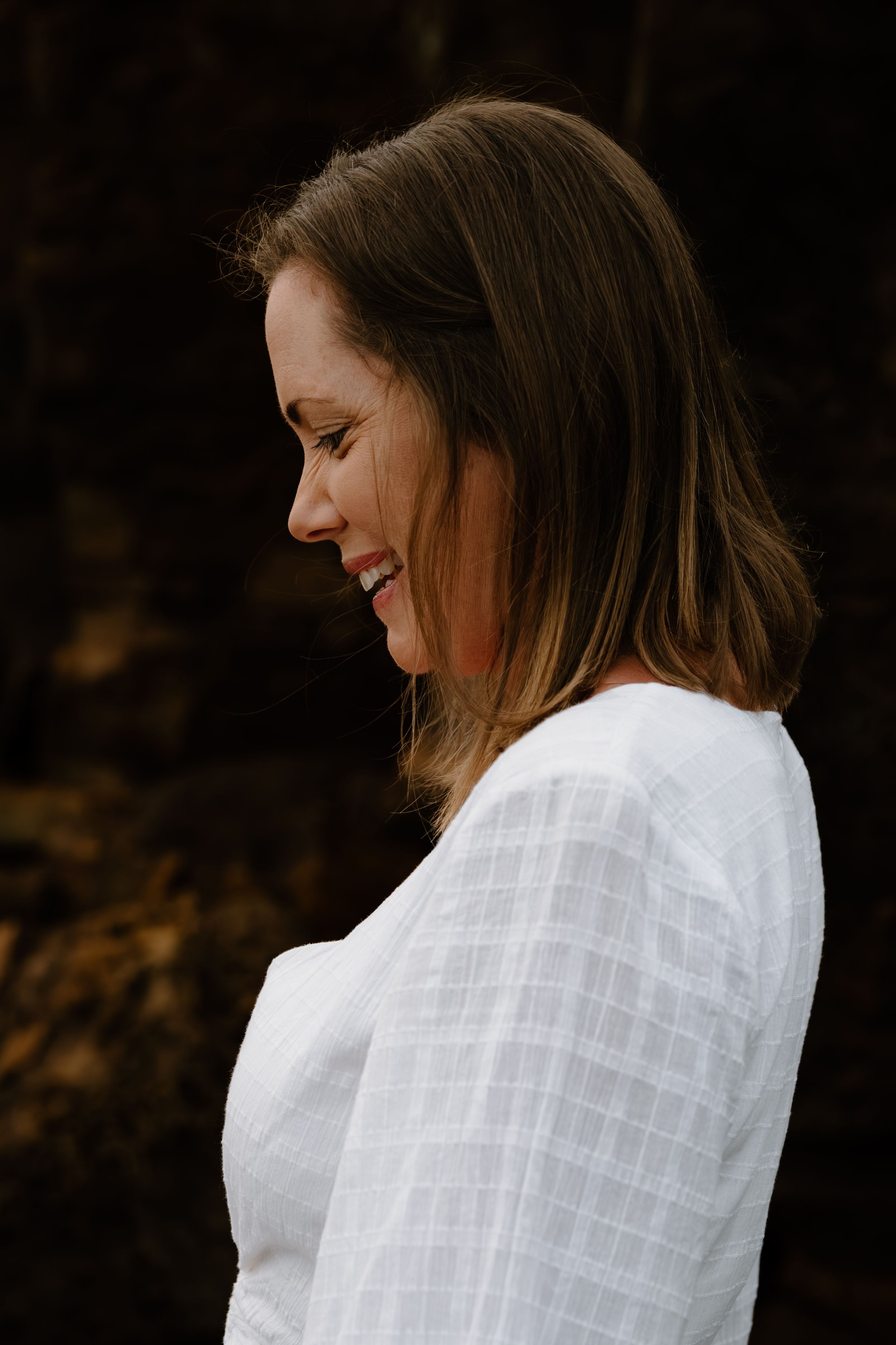 A person in a white textured shirt is shown in a sequence of profile shots against a dark background.
