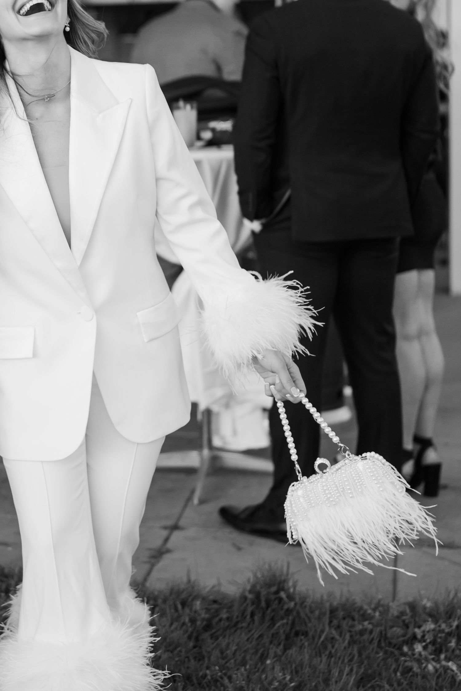 A flowing white dress moves across a dark urban crosswalk in a series of sequential black and white photographs.