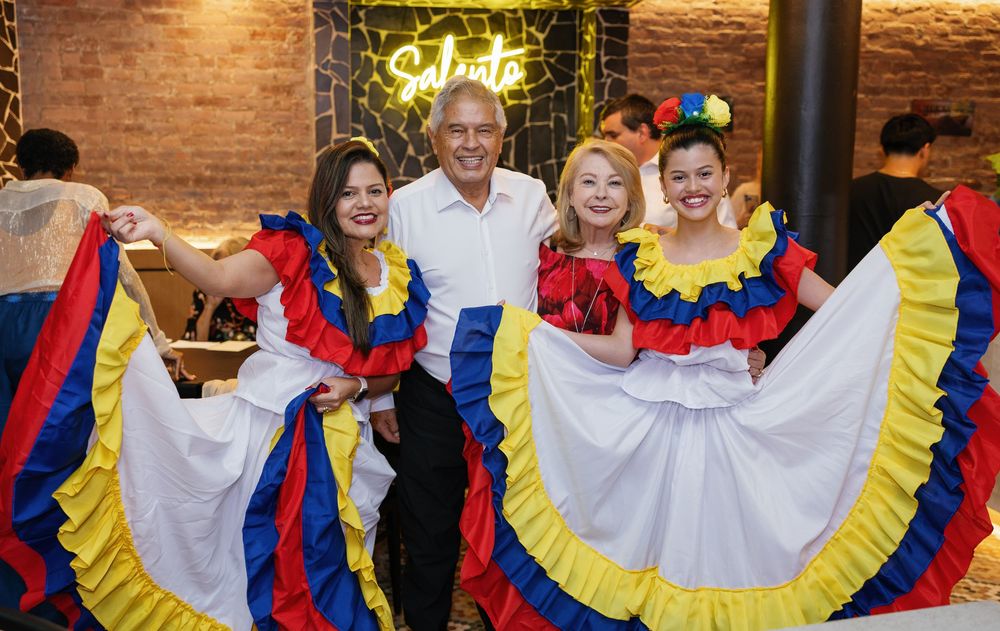Wedding reception dance party with guests wearing colorful traditional Colombian folkloric dresses and outfits.