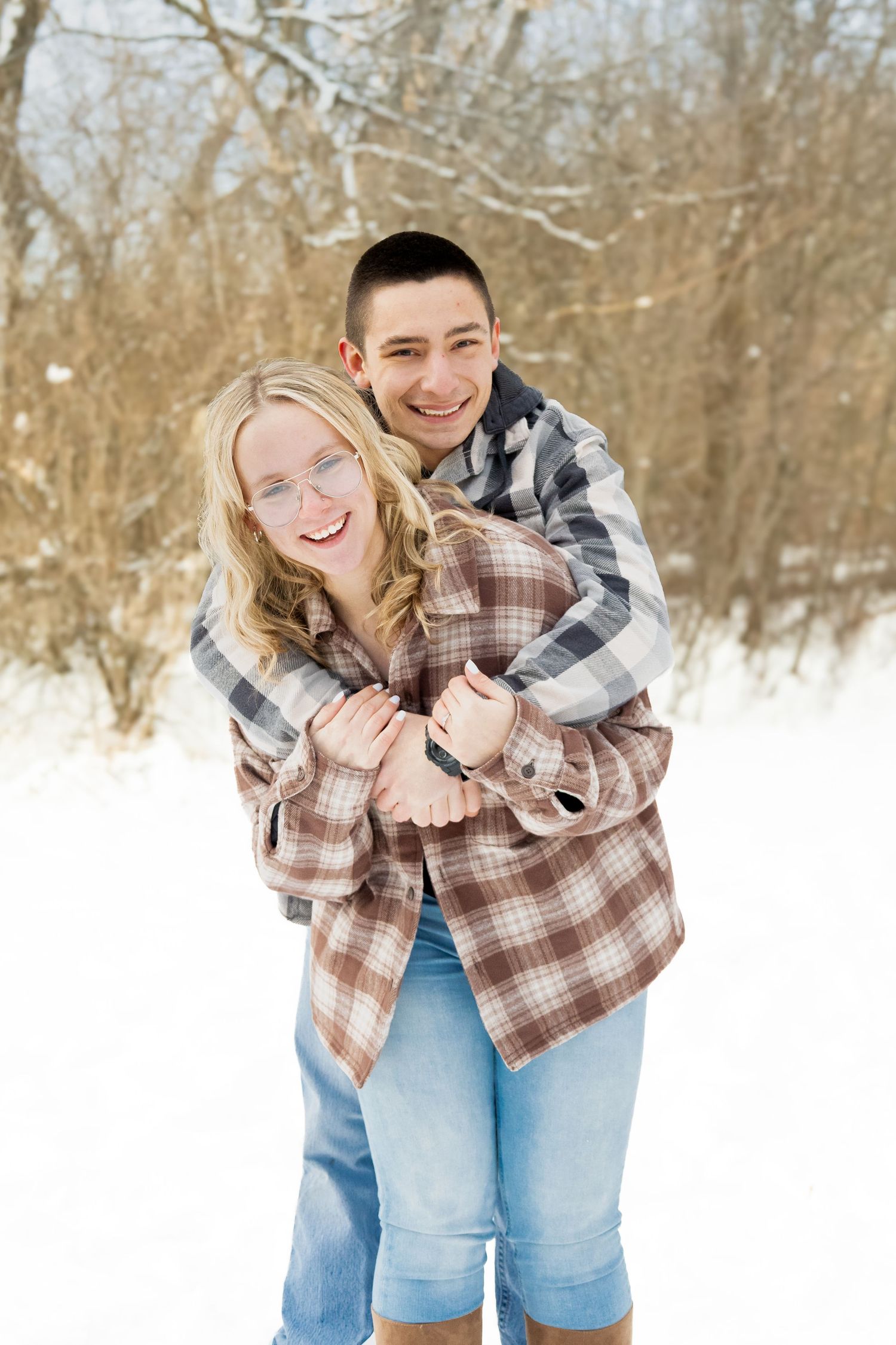 Young couple portrait, outdoors during winter, natural, and candid lifestyle photography in Michigan