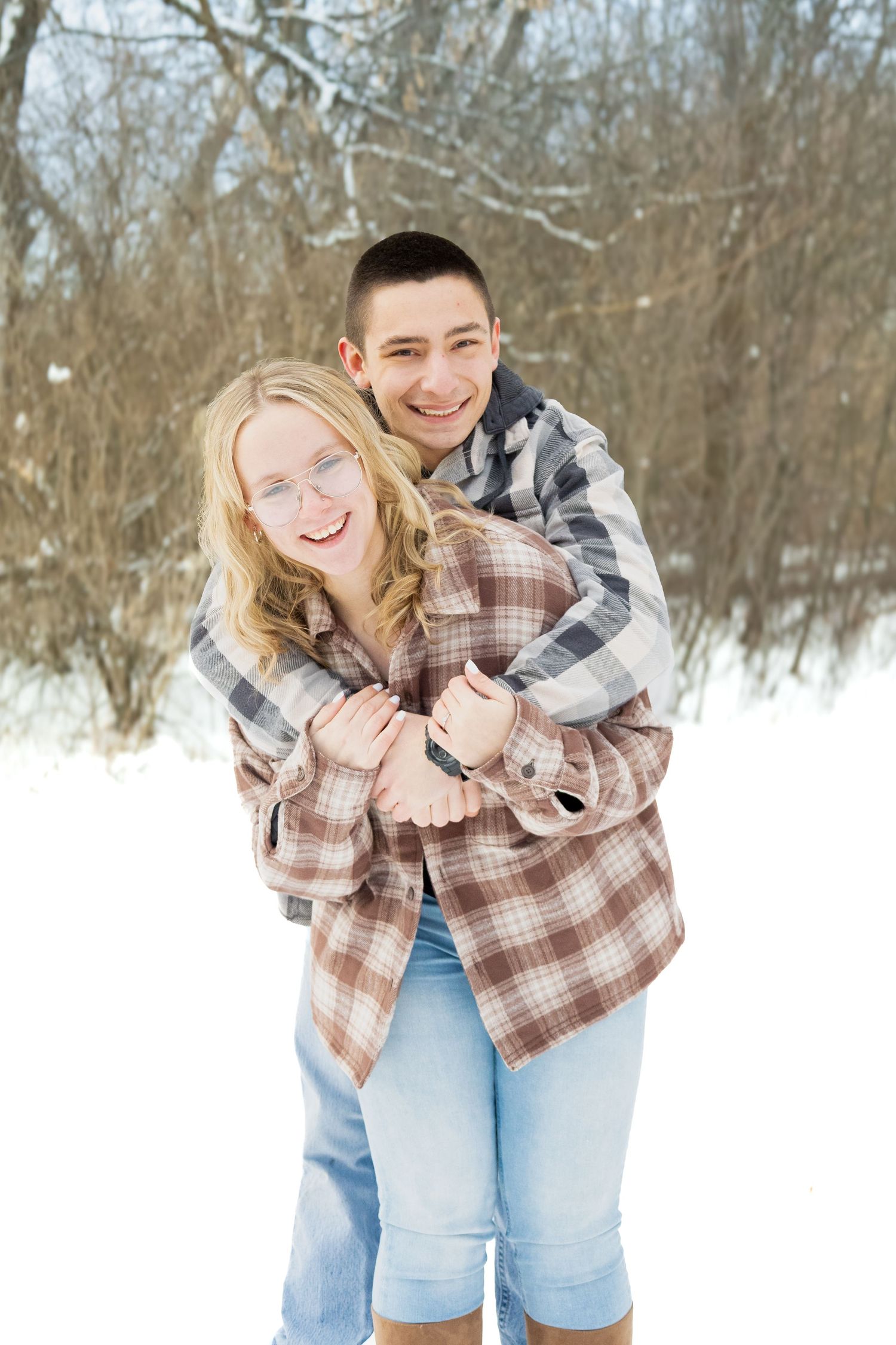 Young couple portrait, outdoors during winter, natural, and candid lifestyle photography in Michigan