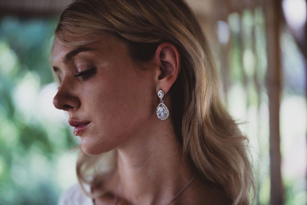 Side profile of elegant bridal jewelry featuring a teardrop earring.