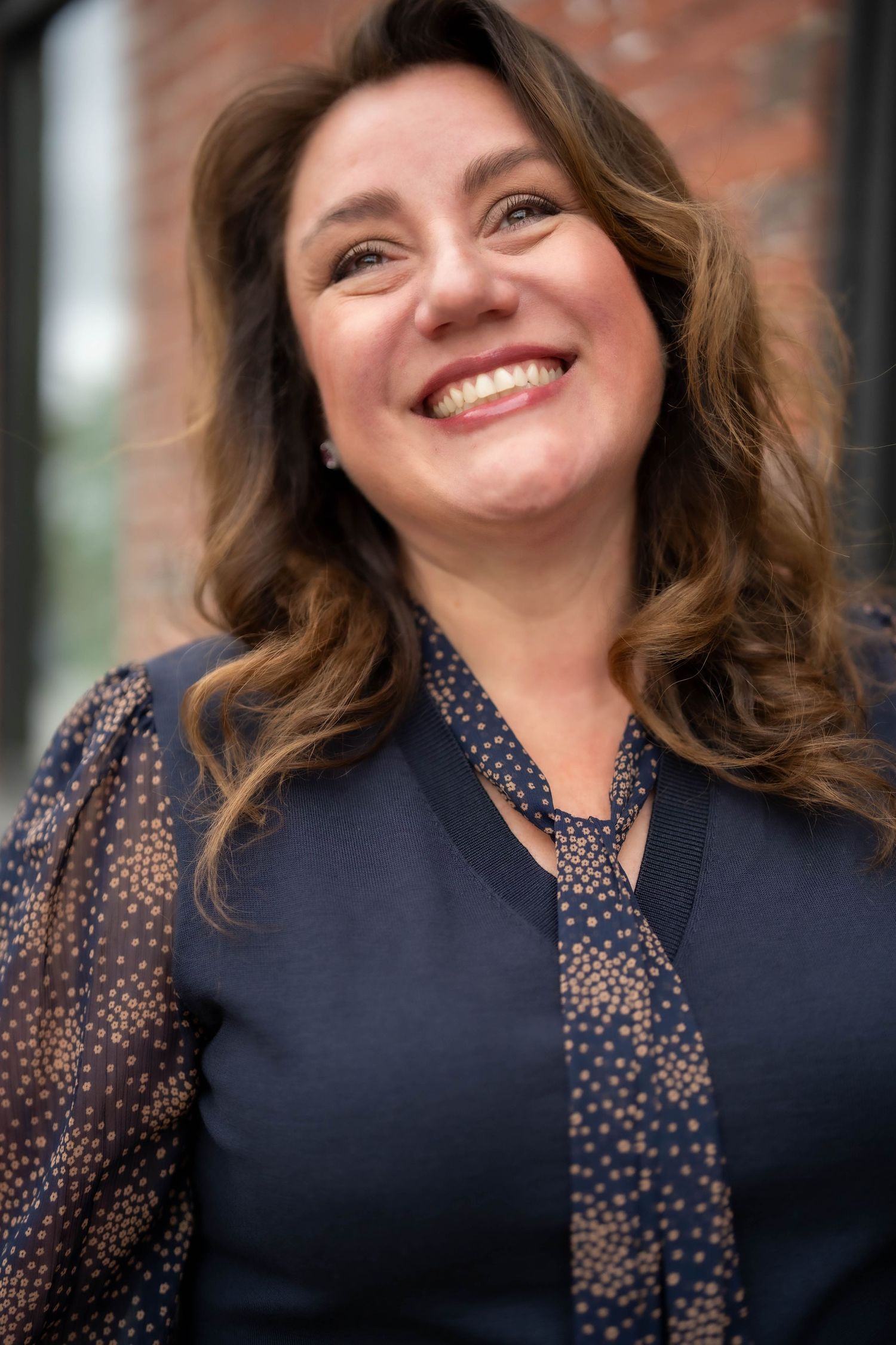 Portrait series showing joyful expressions in navy polka dot blouse.