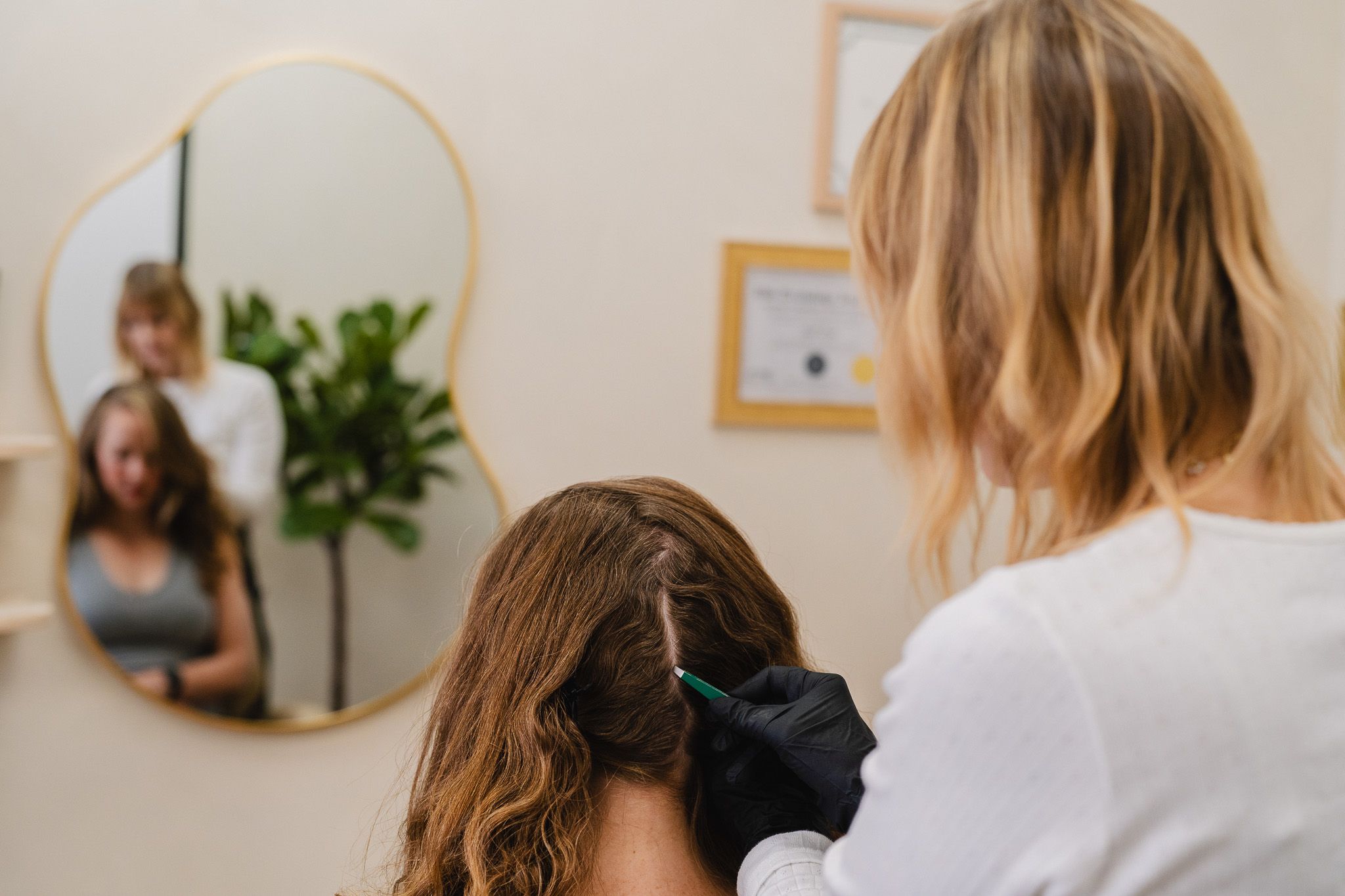 Jill performing a scalp analysis in her Eagle Rock studio captured by a Pasadena branding photographer.
