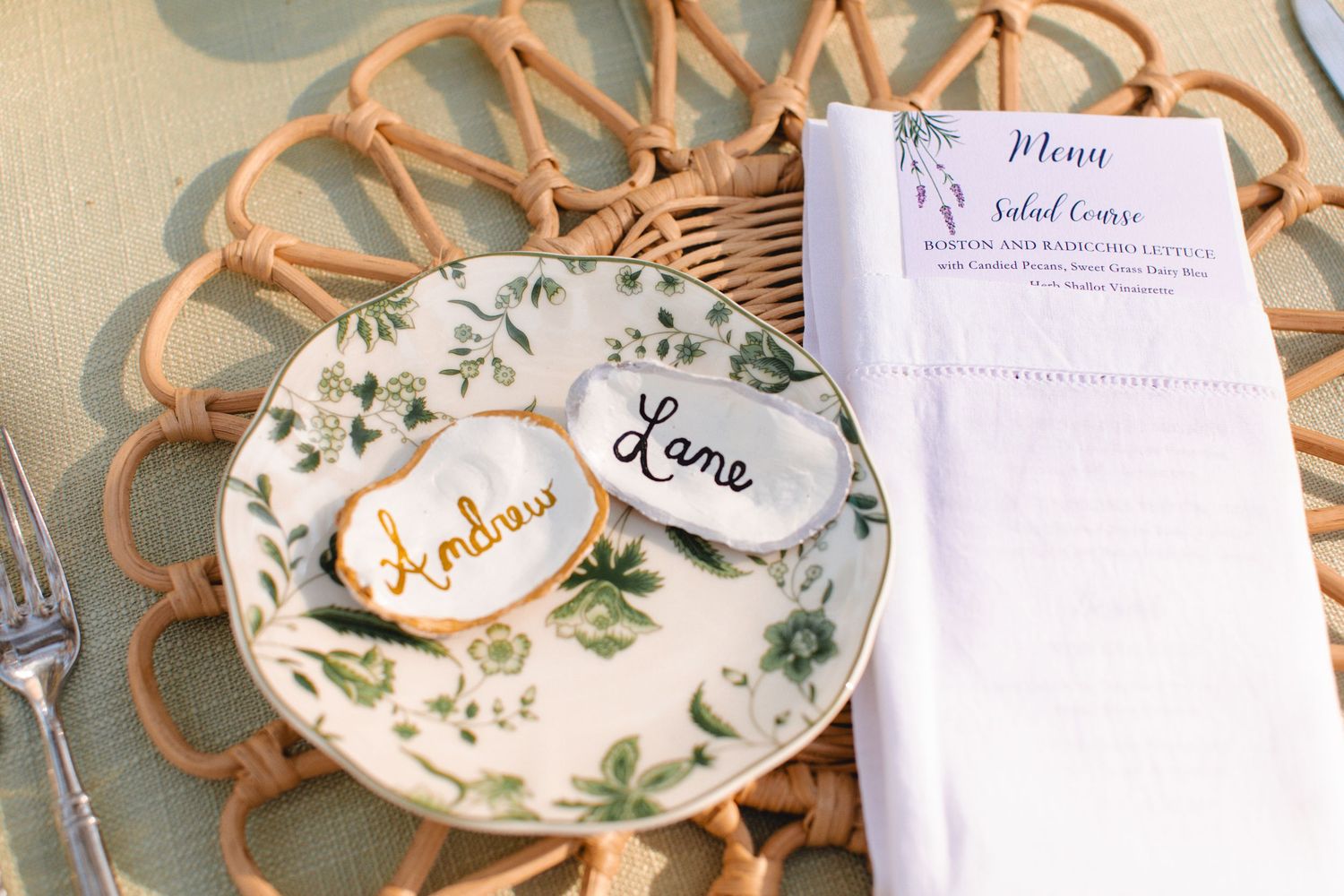 Decorative ceramic plates with floral designs and gold accents displayed on a table.