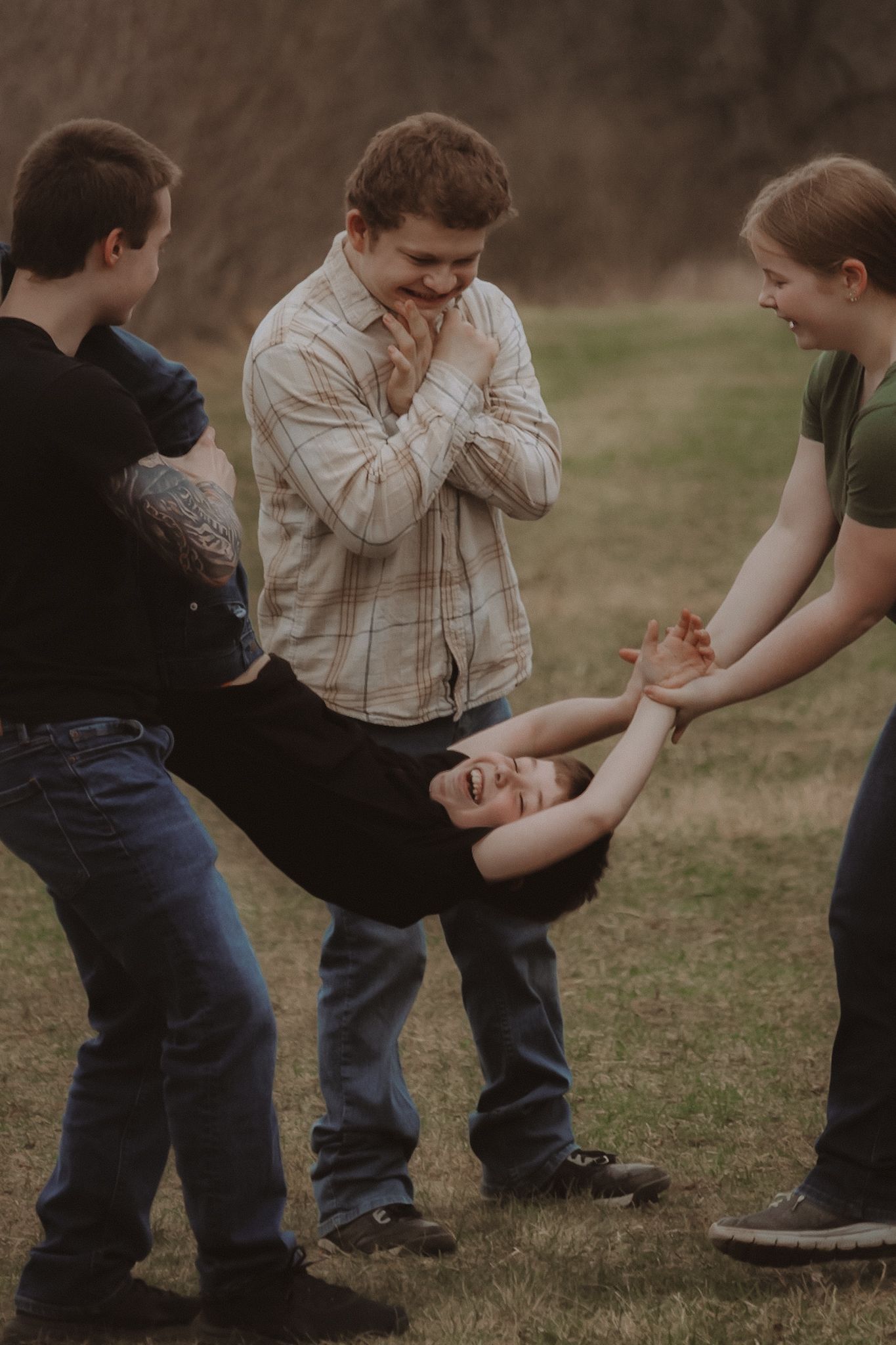 A sequence of playful children engaging in a tag game on grass during a casual outdoor gathering.