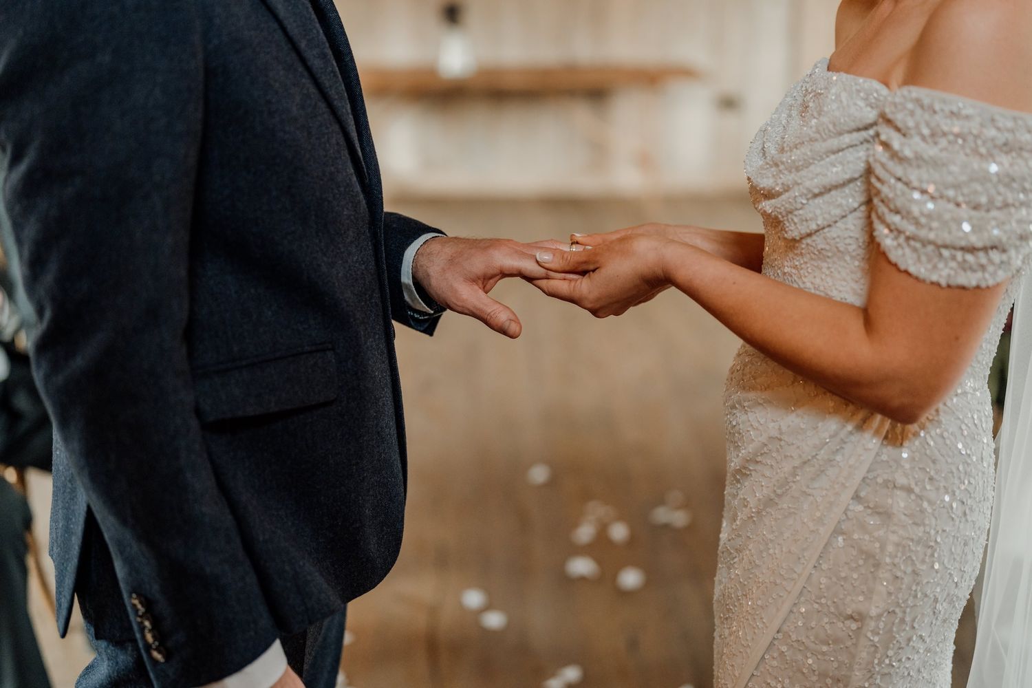 Intimate moment captured between couple showing formal wedding attire details.
