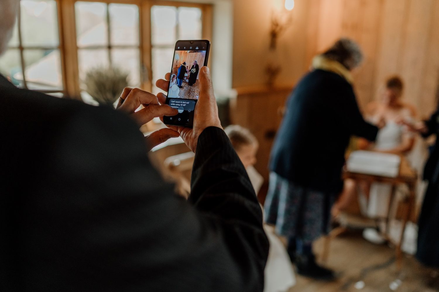 Dimly lit interior shots showing silhouettes of people gathered in a warm, cozy home setting.