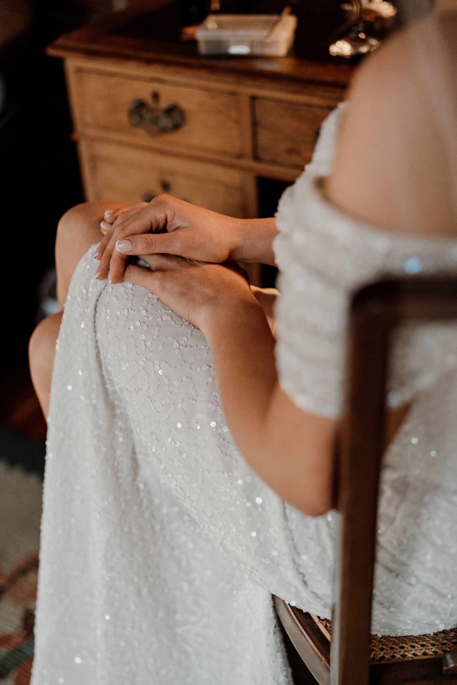 Close-up details of sequined white fabric with delicate beadwork and sparkles.