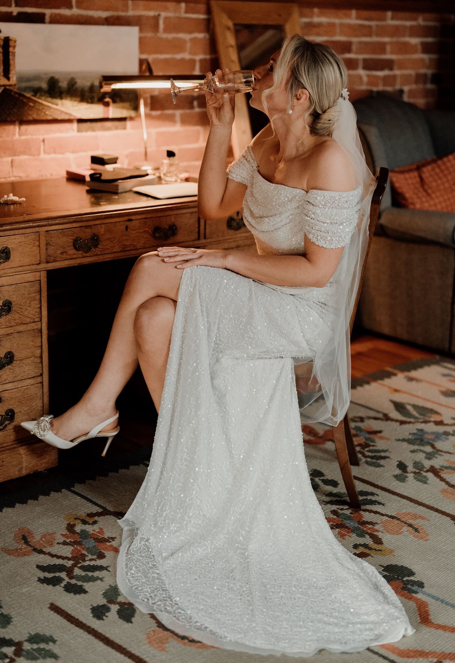 White lace wedding dress photographed from different angles on a patterned rug.