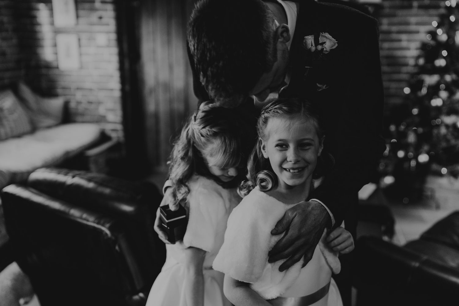 Wedding guests enjoying a candlelit celebration in a dark, intimate setting.