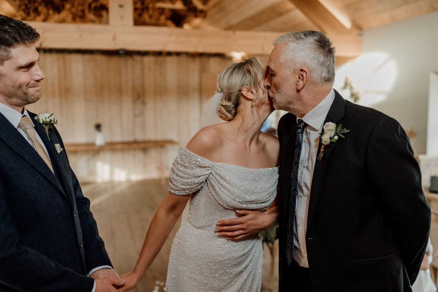 People embracing and sharing emotional moments together during an intimate indoor celebration event.